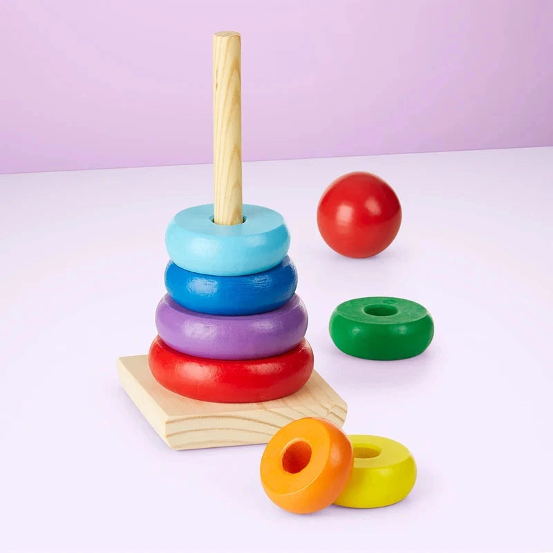 Wooden Rainbow Stacking Rings — toddler placing a ring